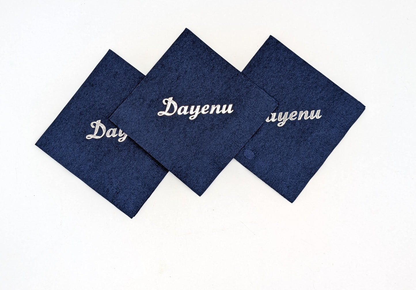 grouping of 3 navy napkins that say dayenu