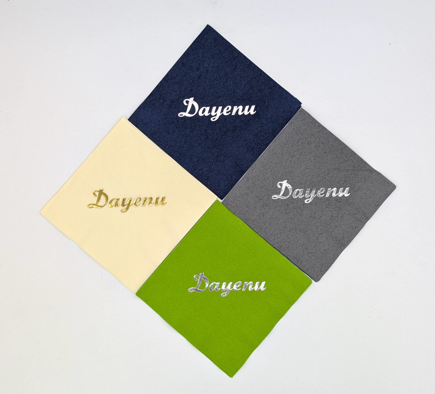 grouping of 4 napkins that say dayenu