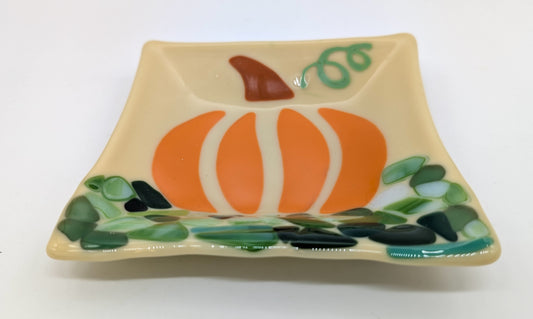 glass square plate with an image of a pumpkin in a field