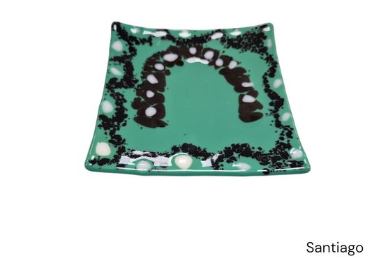 Colorful green wavy glass plate, with black and white dots.&nbsp;