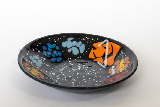 black plate with solar system around the edges