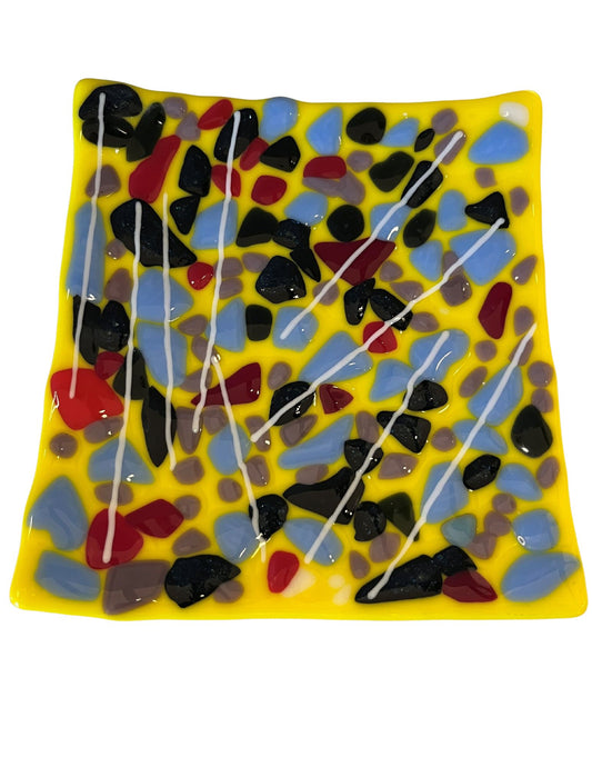 yellow glass plate with blue, red, and black