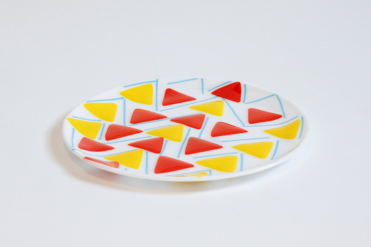 white glass plate with yellow and orange triangles