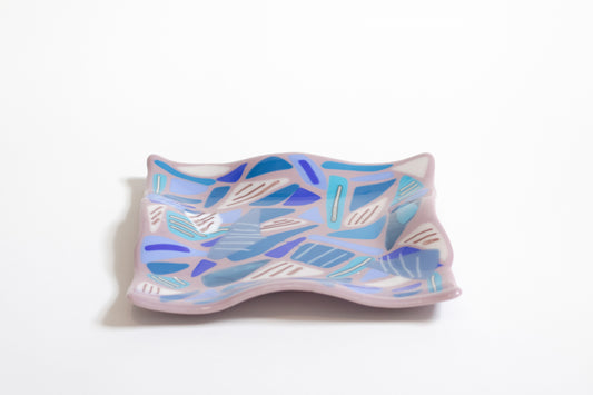 purple glass wavy plate with blue and white triangles with lines on top