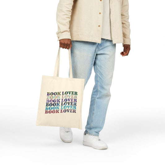 canvas tote bag with a rainbow of colors that repeat book lover