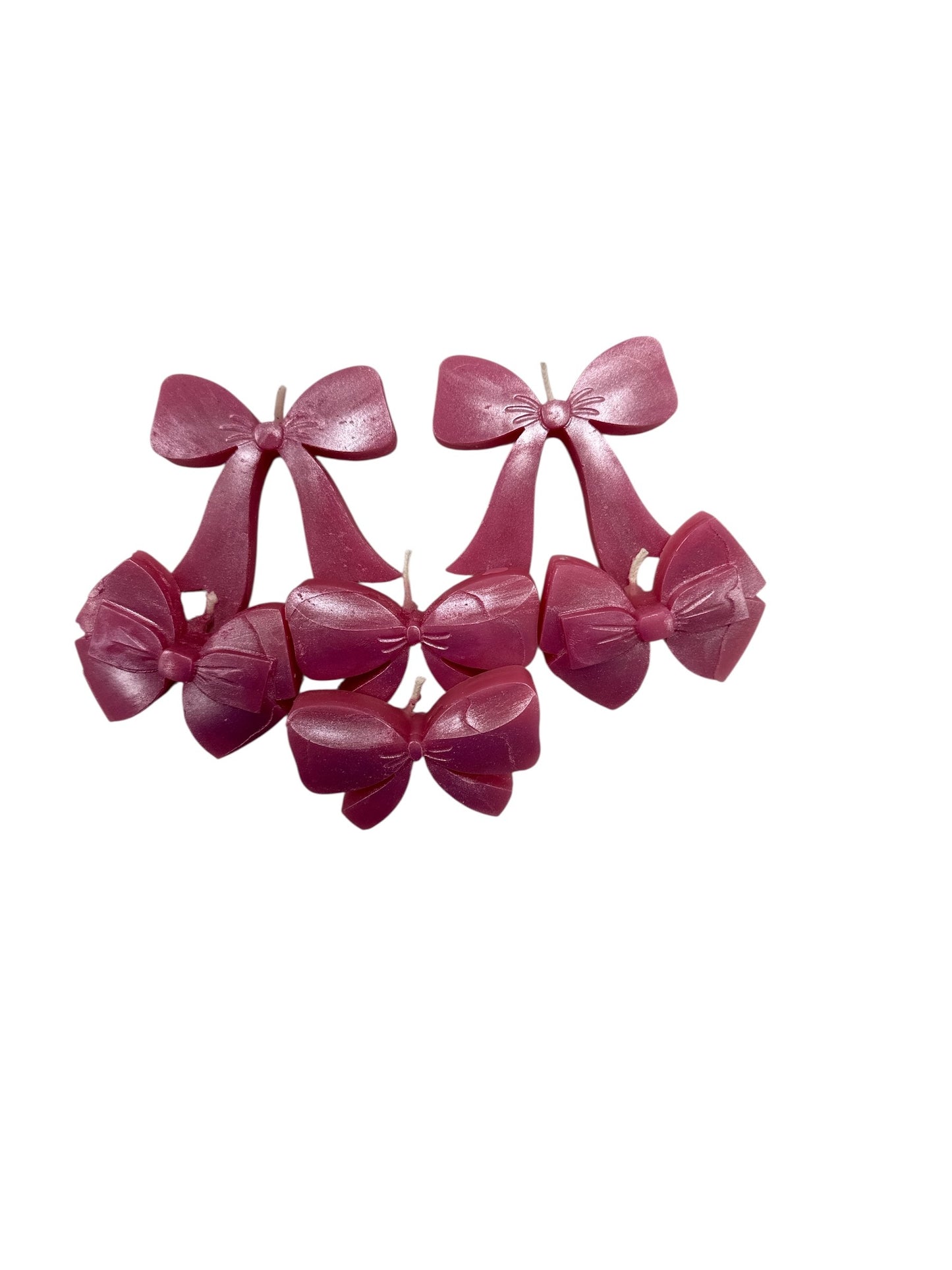 Set of pink plastic bows on a white background