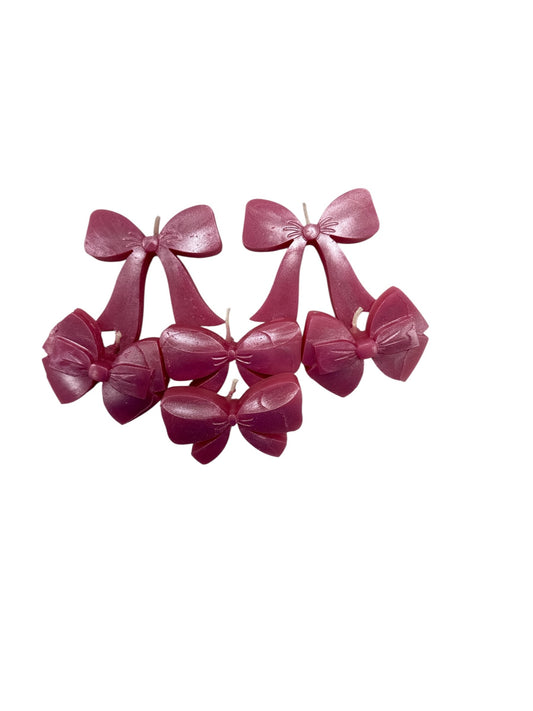 Set of pink plastic bows on a white background