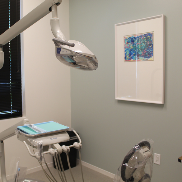 colorful dots celebration company painting displayed on the wall of a dental exam room.