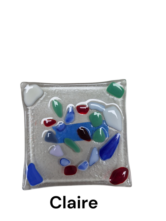 Handcrafted fused glass art tray, it displays a vibrant, spontaneous arrangement of multi-colored glass "pebbles"including pops of red, deep blue, green, and white, embedded within a textured, frosted glass surface.