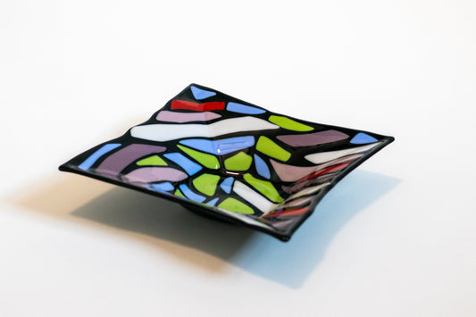 Black fused glass bowl with colorful designs