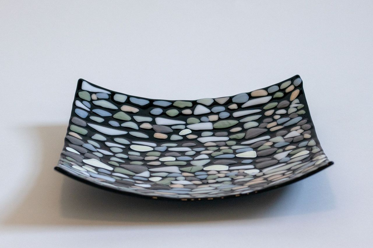 black square bowl with various shades of gray and white dots on top