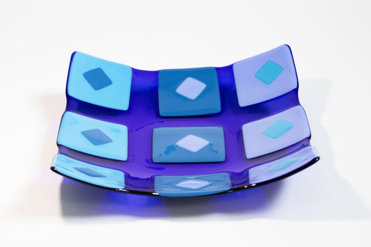 Square blue glass bowl with various shades of blue squares and diamonds