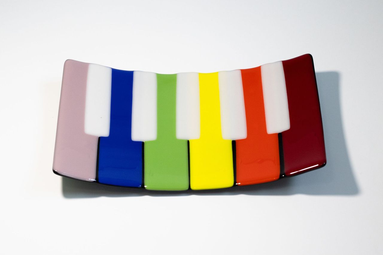 Rectangle glass bowl that looks like a piano with rainbow keys 