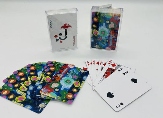 playing cards of a Painting of various colored shapes with patterns on top of them, some of them are planets, stars, and ovals ontop on a background that is divided into thirds of red, light blue, and dark blue