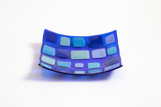 blue glass plate with various sized blue squares on it