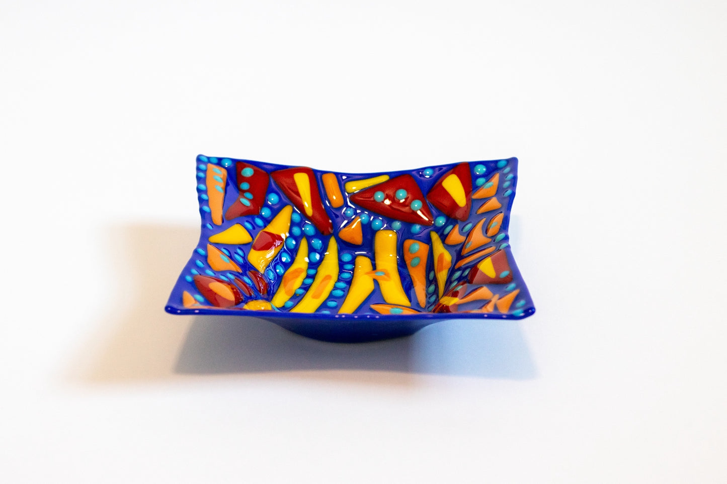 blue bowl with yellow , orange, and red