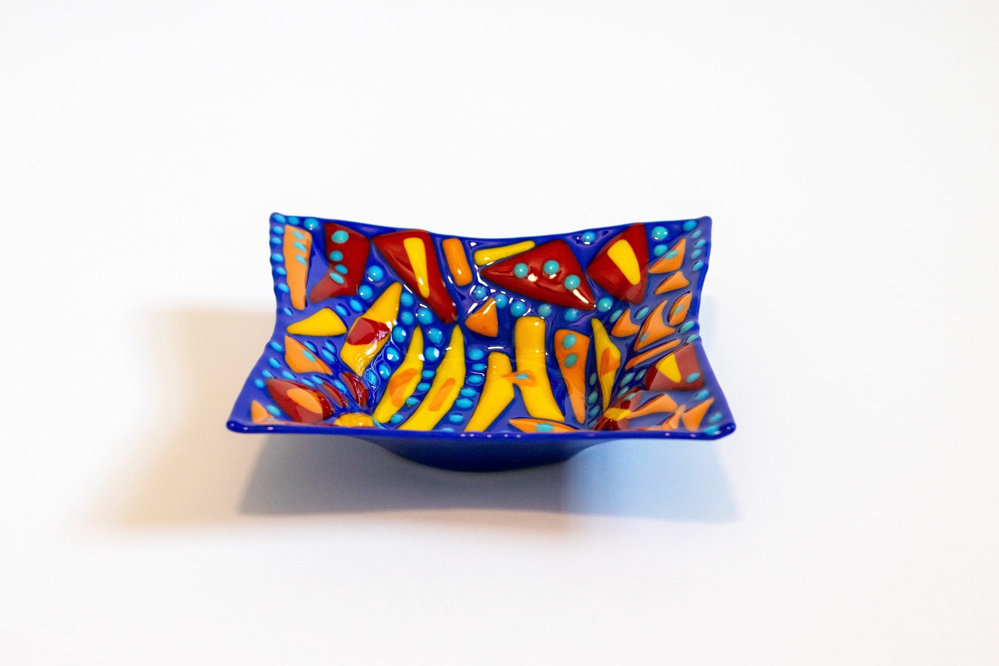 blue bowl with yellow , orange, and red