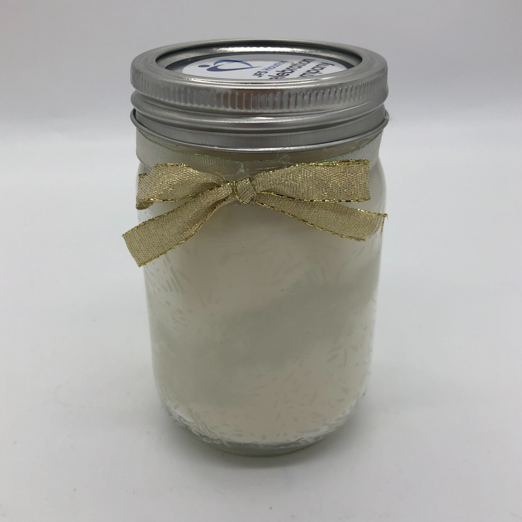 Canning jar with a white candle inside, white candy sprinkles decorating the sides.  Gold metallic bow on the outside.