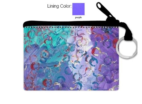 This is a coin purse with a black zipper and silver key ring with the following painting: This is a painting with a green and purple background and circular imprints on top in red white and blue