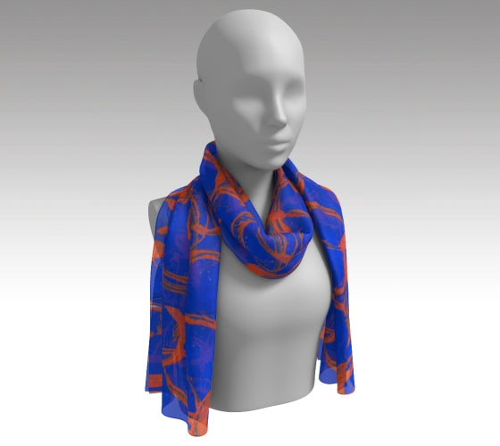 Mannequin wearing a royal blue scarf with orange large rings