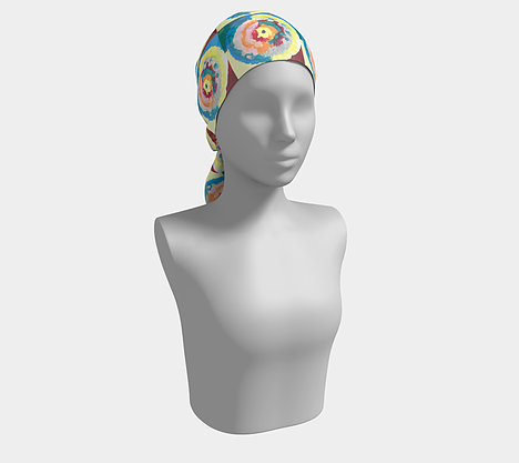 Mannequin wearing a colorful headscarf with circle within circle design with blue, green, orange, pink, yellow and red colors