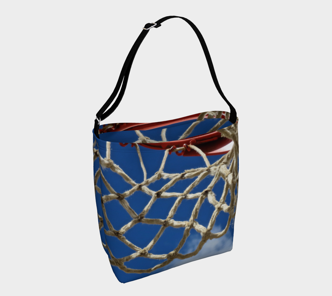 Crossbody totebag with single black strap with blue background and close up view of white basketball netting and red basketball rim
