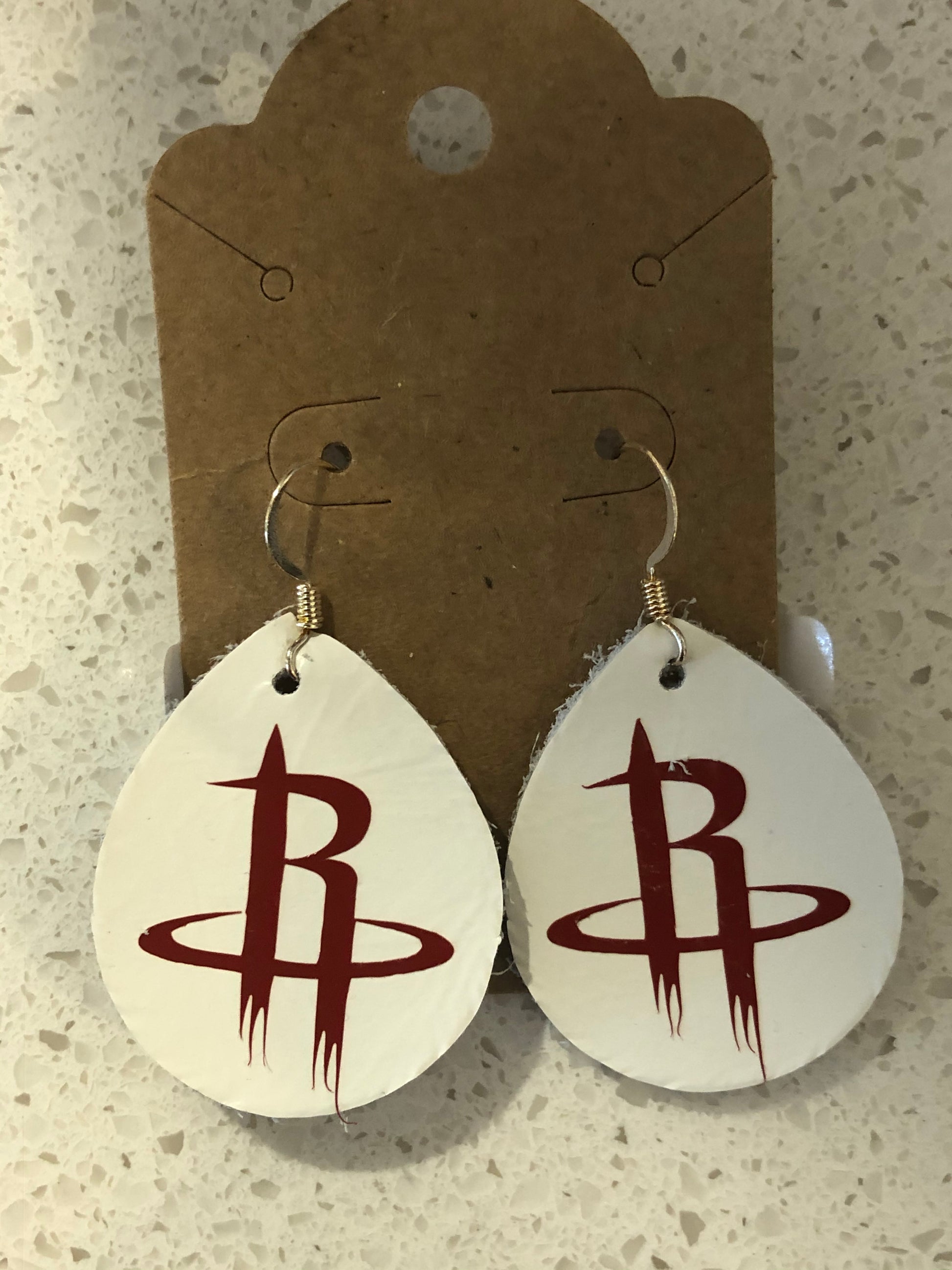 Tear drop shaped white leather earrings with Houston Rockets logo