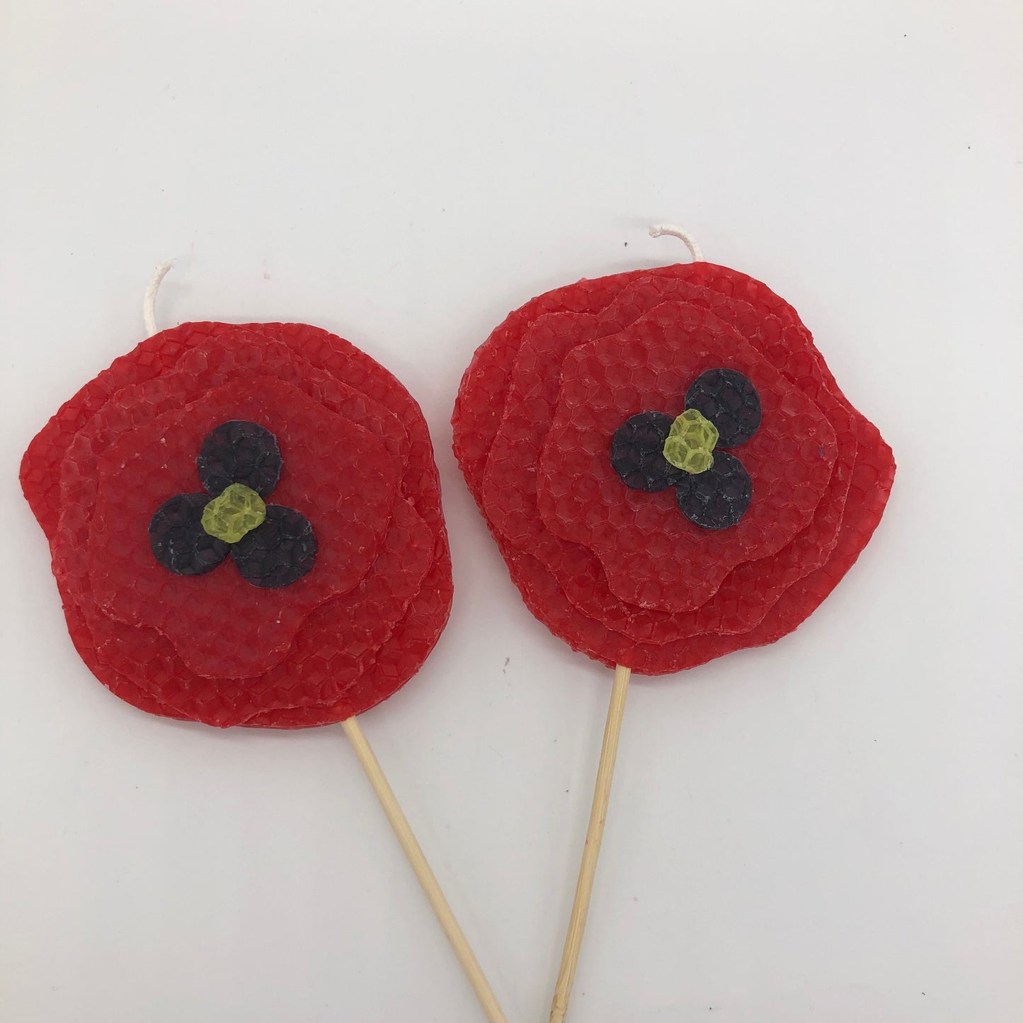 Two large red poppy beeswax candles