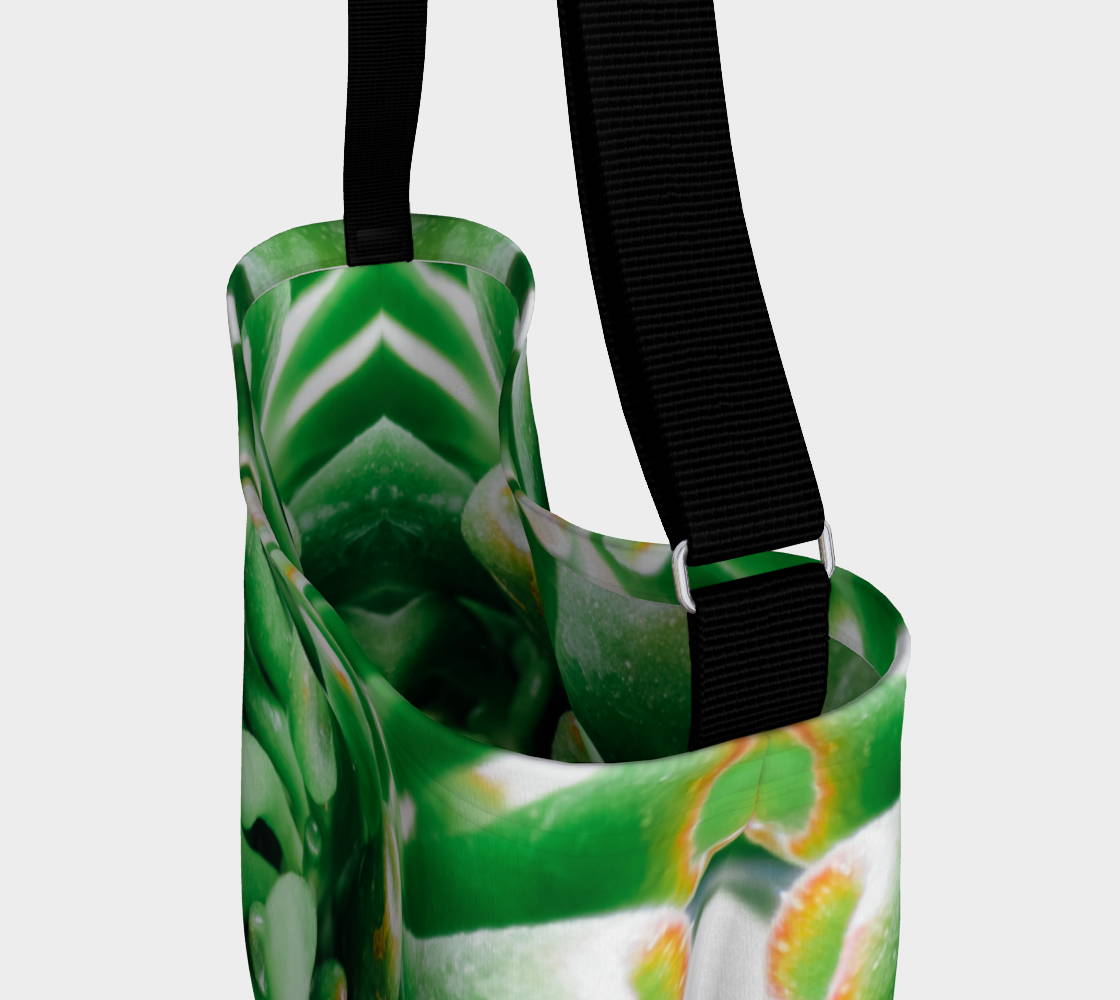 Close up view of Crossbody totebag with single black strap depicting close up view of green succulent plant