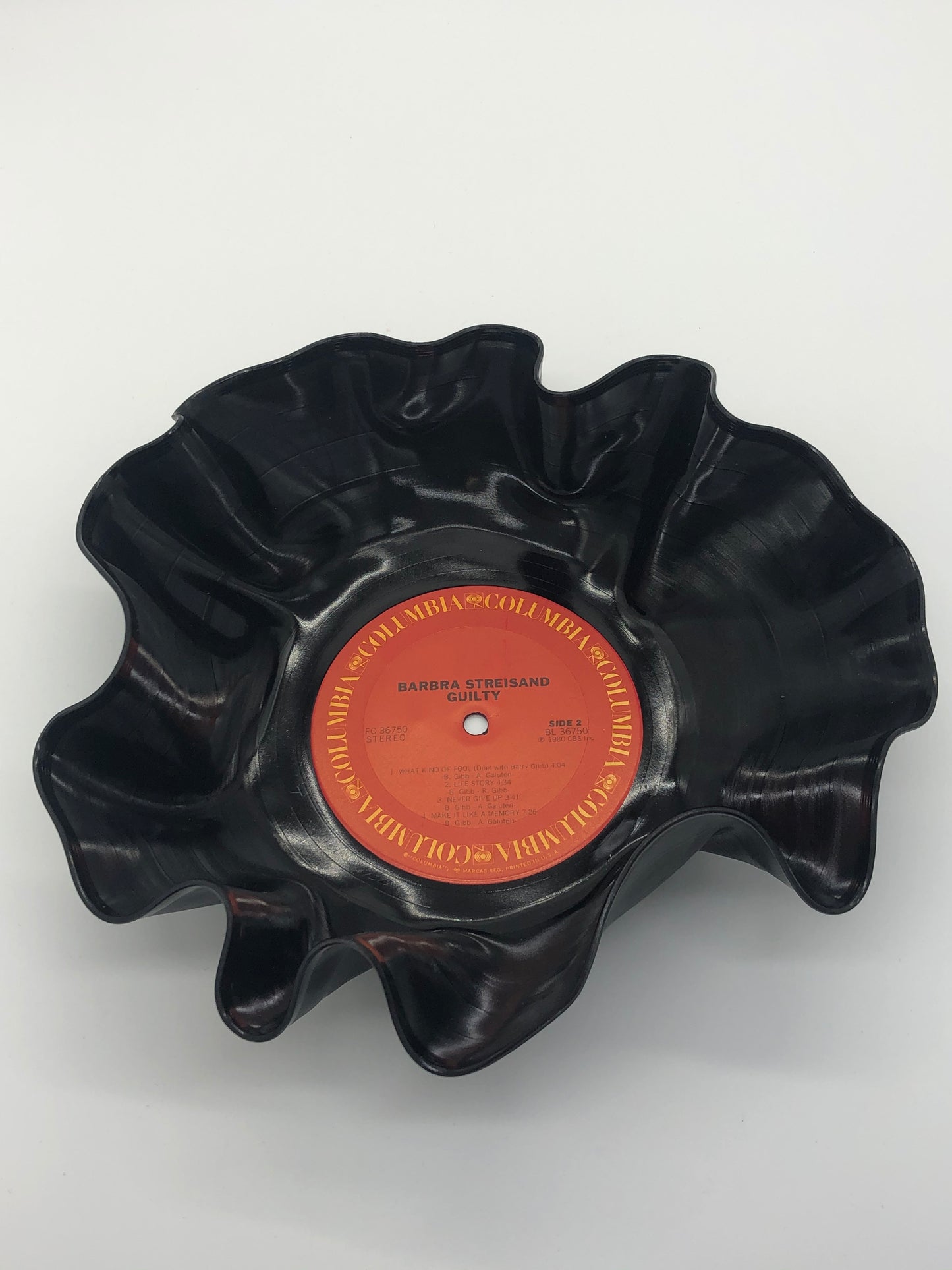 Black bowl with ruffled edges made from a melted record