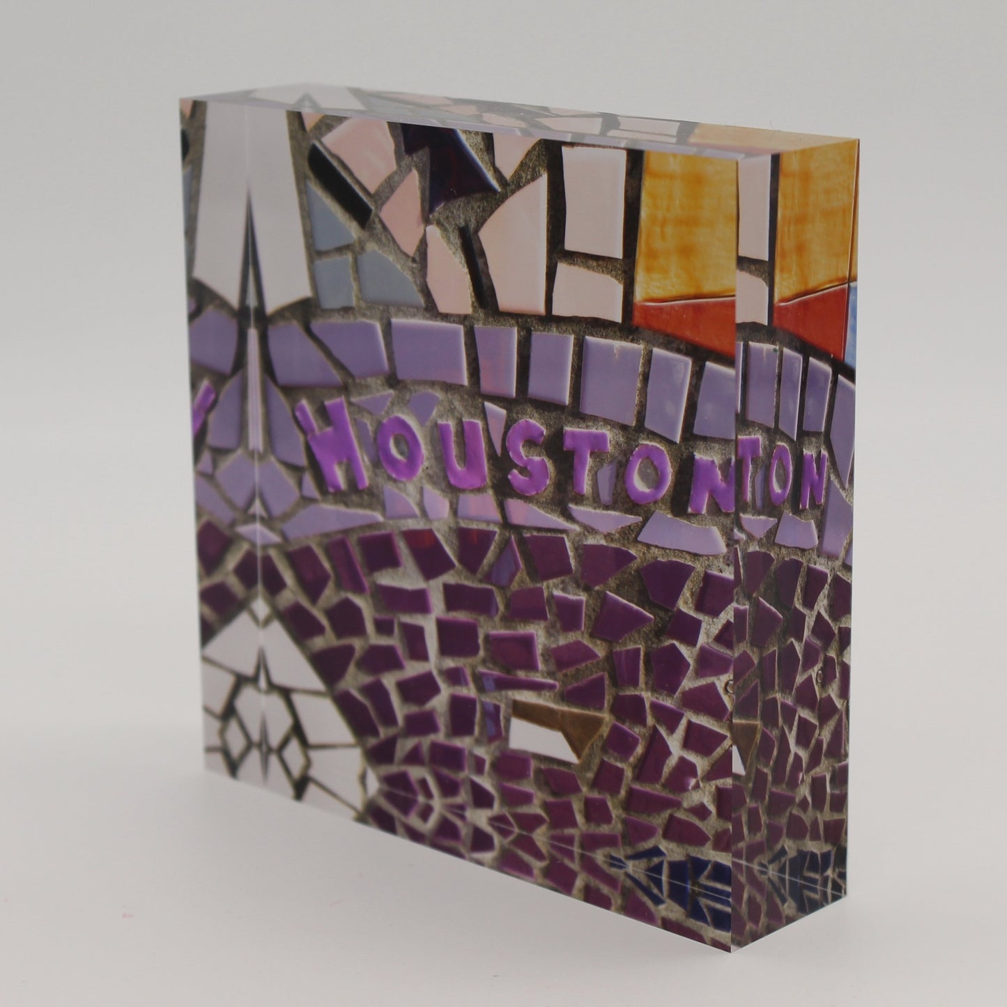 Tilted view of Acrylic block picture of mosaic tiles spelling Houston