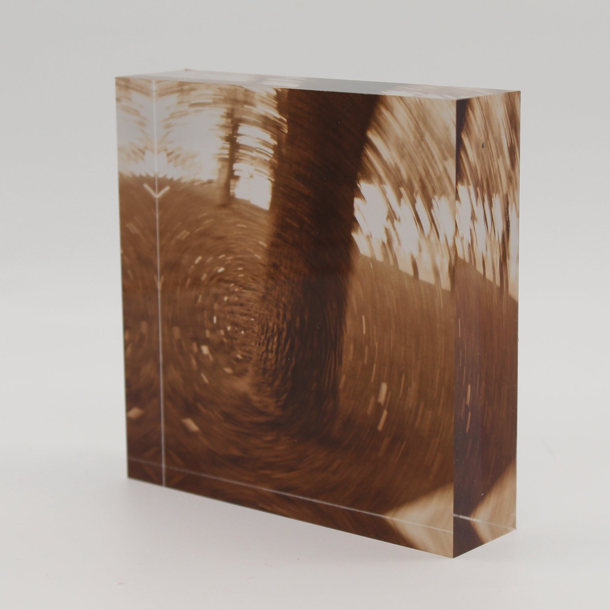 Tilted view of Acrylic block depicting tree trunk in motion