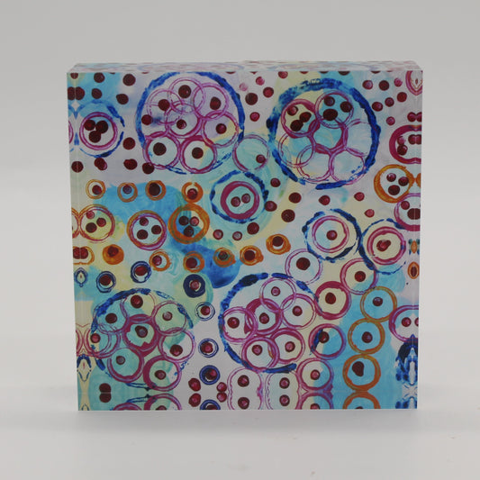 Acrylic block picture of blue, pink, and orange circles with maroon dots