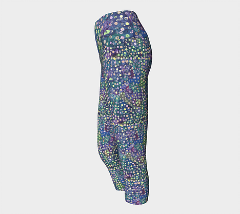 Side view of Yoga capri leggings with blue, green and purple swirl background with yellow, green and pink dots