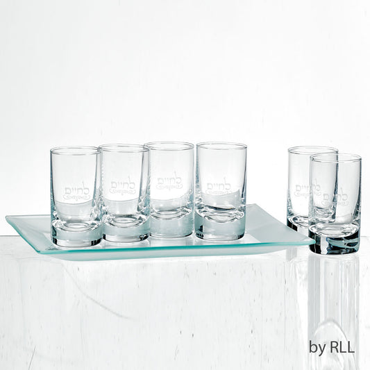 Six glass shot glasses with L'Chaim etched into the middle on a frosted glass tray