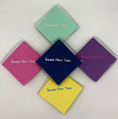 Seafoam, pink, blue, purple and yellow packaged napkins all depicting Sweet New Year slogan