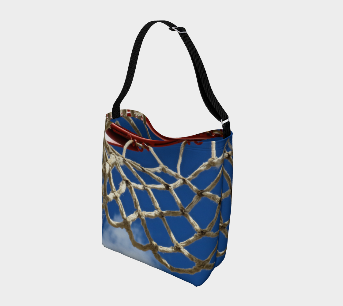 Crossbody totebag with single black strap with blue background and close up view of white basketball netting and red basketball rim