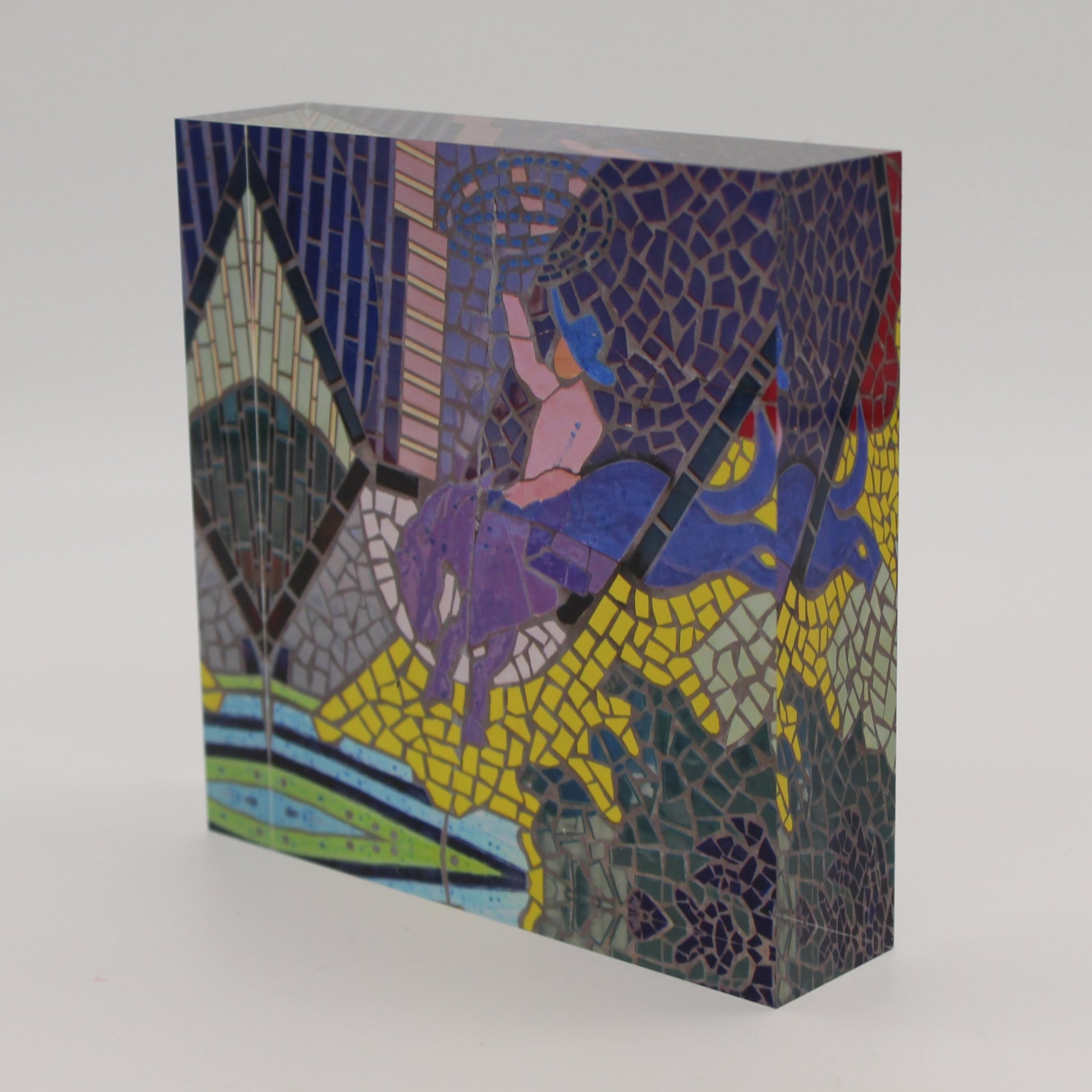 Tilted view of Acrylic block with mosaic tiles depicting a cowboy on a bucking bronco