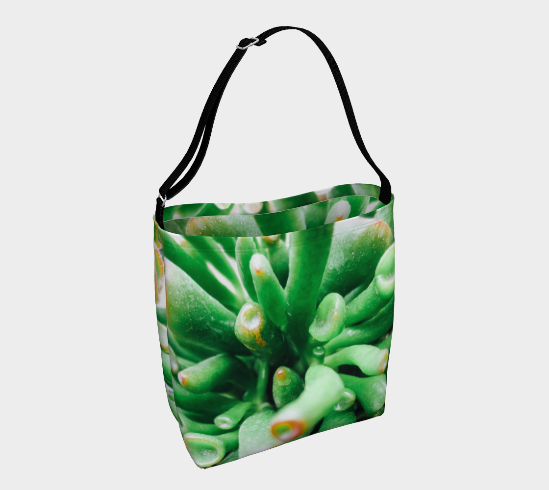Crossbody totebag with single black strap depicting close up view of green succulent plant