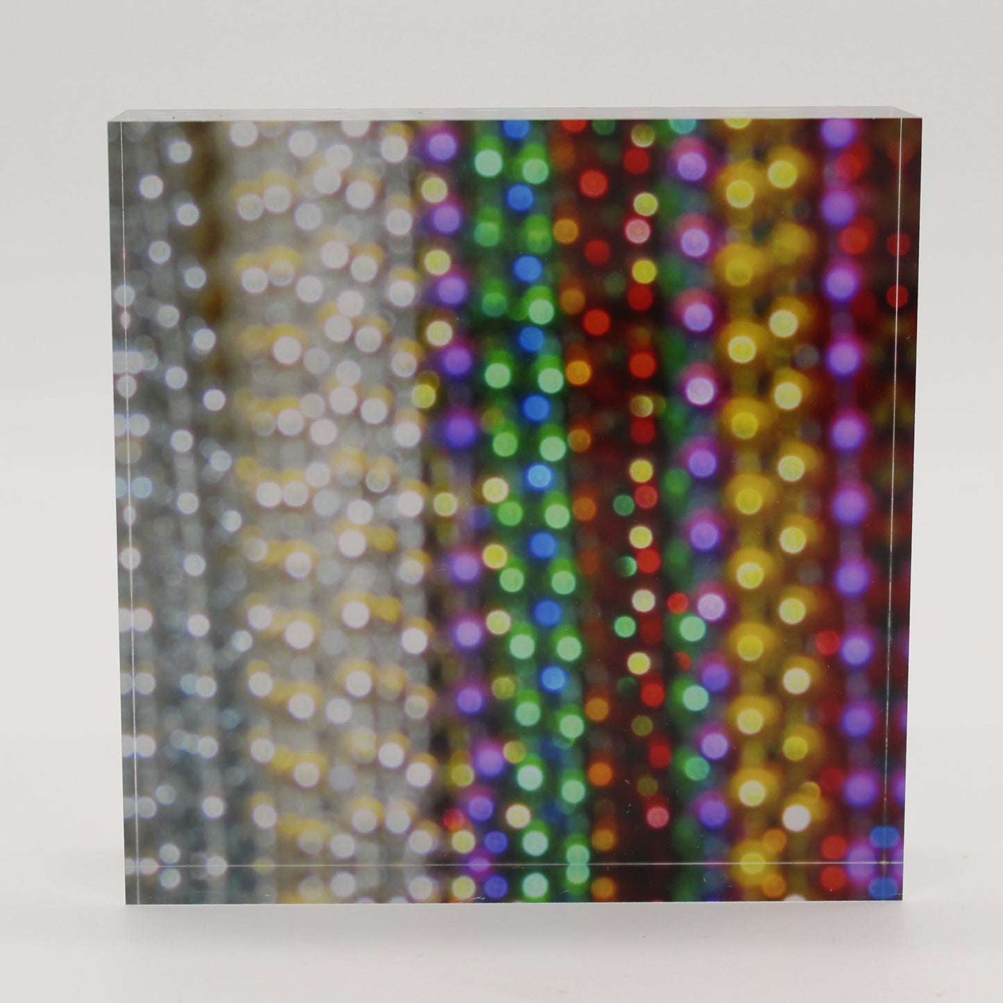 Acrylic block depicting close up view of bead strands