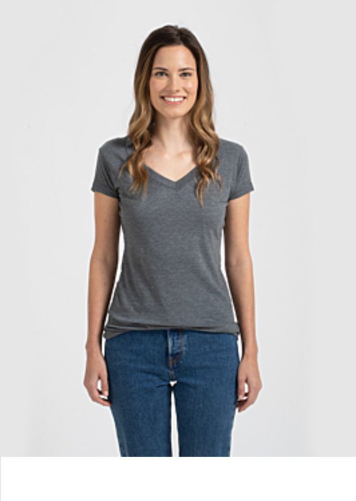 Stock photo model with brown hair smiling and wearing gray t-shirt and jeans
