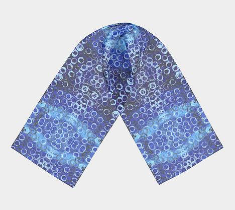 Flat lay view of scarf with gradient blue background with white and black circles overlaid