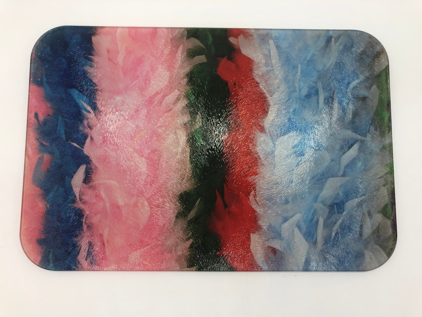 Rectangular glass cutting board with dark blue, pink, green, red, and light blue feather boas