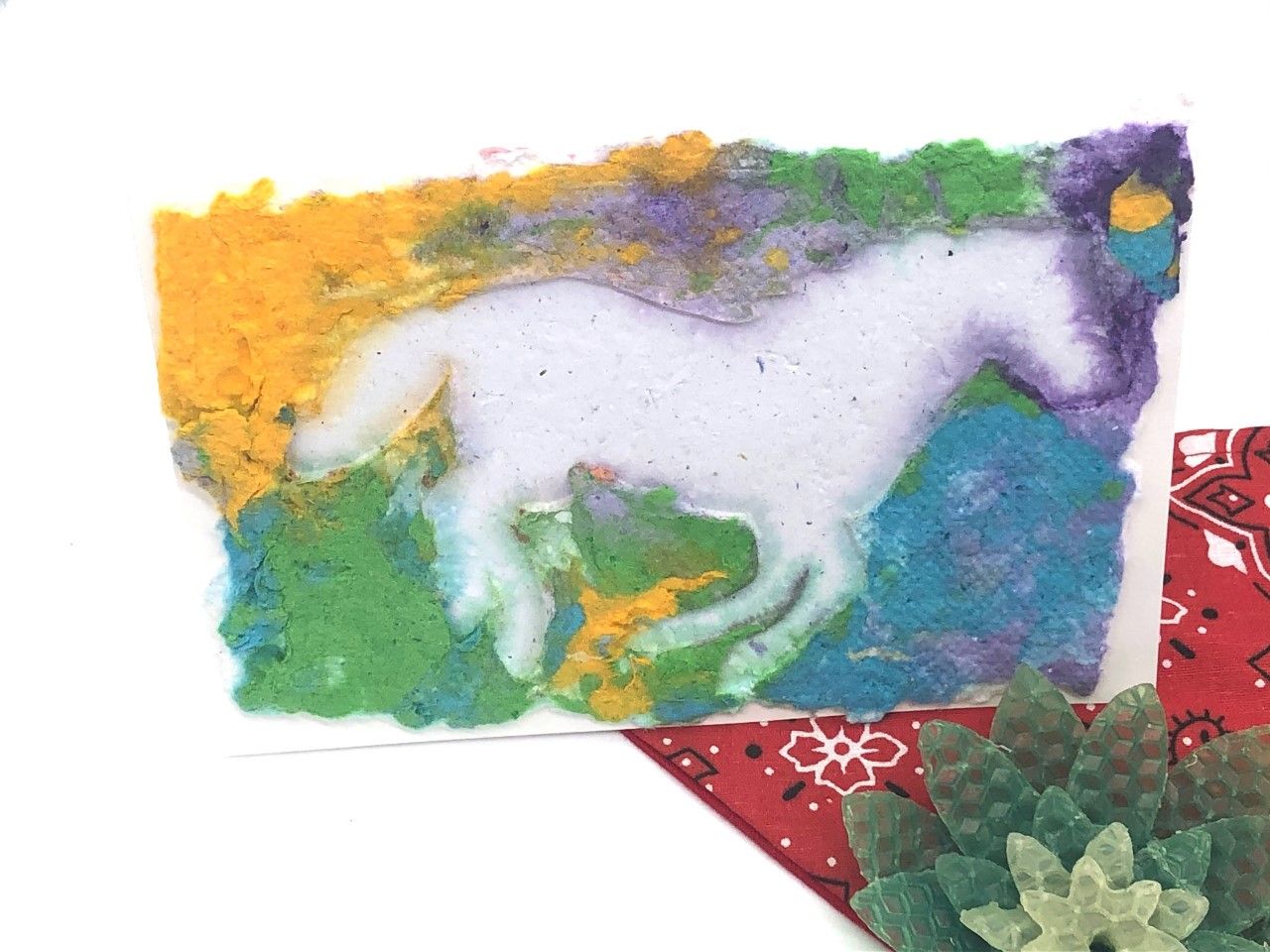 card with handmade paper design of a horse. vivid colors of purple, yellow and green