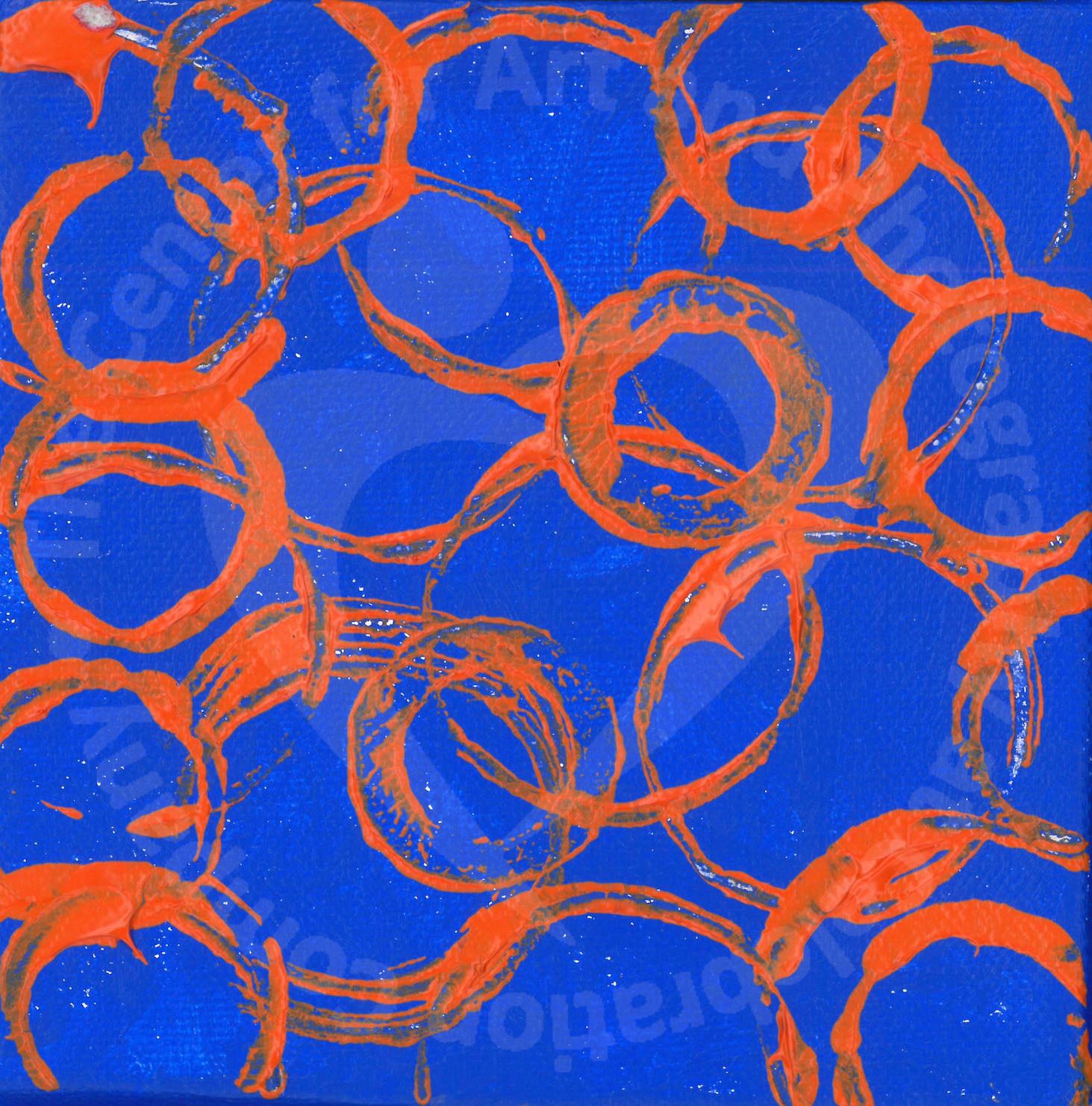 Bright orange circle impressions overlapping against a bright blue background