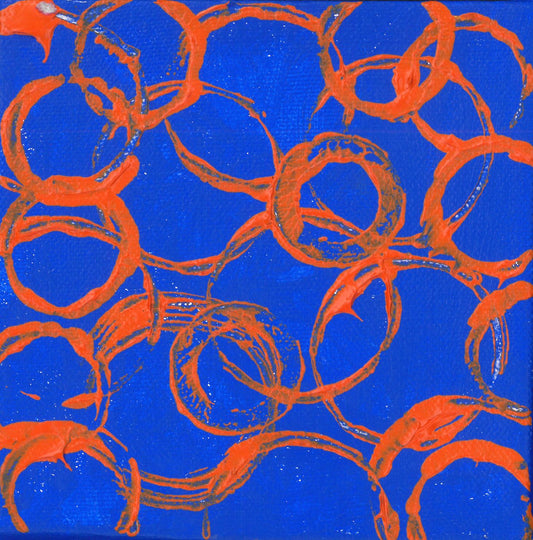 Bright orange circle impressions overlapping against a bright blue background