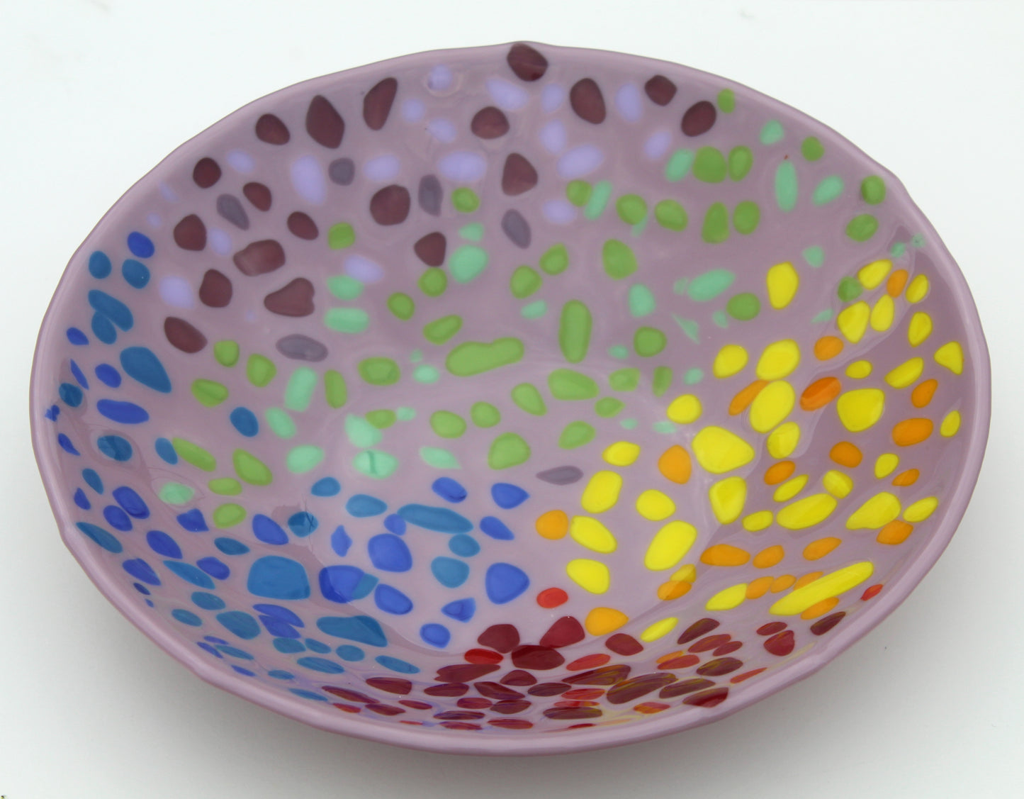 purple glass bowl with spots of red, yellow, green, and blue sectioned off