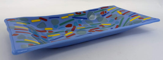 Light blue glass tray with scatters of blue, yellow, red, and green lines with stones of transparent colors