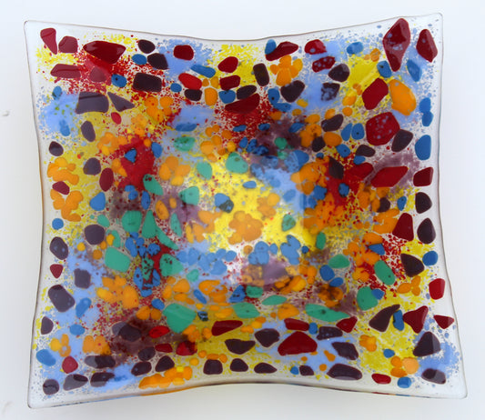 clear glass rectangle bowl with spots of red, purple, orange, blue, and green. Completely filled in with yellow, blue, red, and purple areas