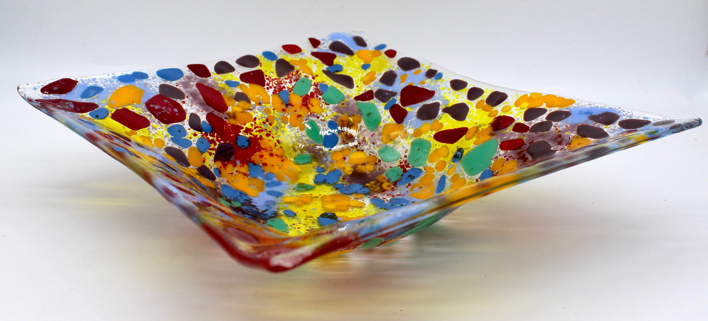 clear glass rectangle bowl with spots of red, purple, orange, blue, and green. Completely filled in with yellow, blue, red, and purple areas